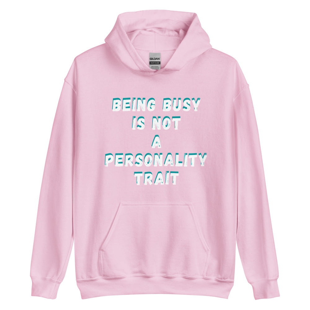 This is a funny hoodie sweatshirt. It is pink and has "Being busy is not a personality trait" written across the front in white writing with an aqua shadow.