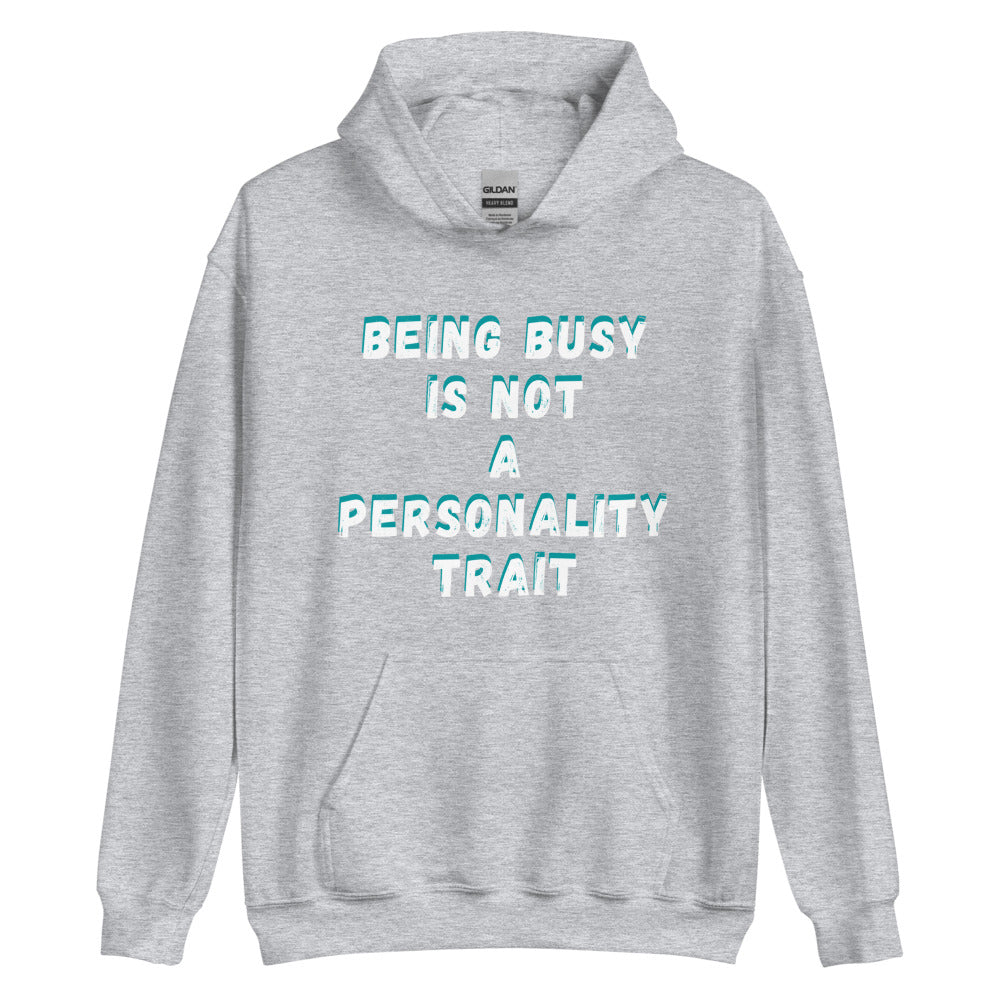 This is a funny hoodie sweatshirt. It is light grey and has "Being busy is not a personality trait" written across the front in white writing with an aqua shadow.